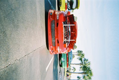 1991 Ford Probe - A red sports car is parked in a lot with its hood open, showing the engine.