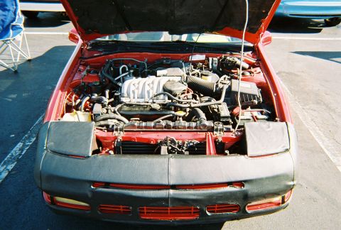 1991 Ford Probe - Front view of a 1991 Ford Probe's engine bay, hood raised, revealing the engine components.