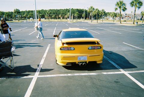 1991 Ford Probe - Rear view of a yellow 1991 Ford Probe in a parking lot.