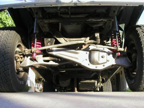 1984 Ford Bronco - Undercarriage view reveals suspension and drivetrain details of the vehicle.