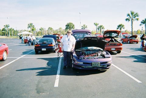 1991 Ford Probe - A purple Ford Probe is displayed with its hood open at an outdoor car show.