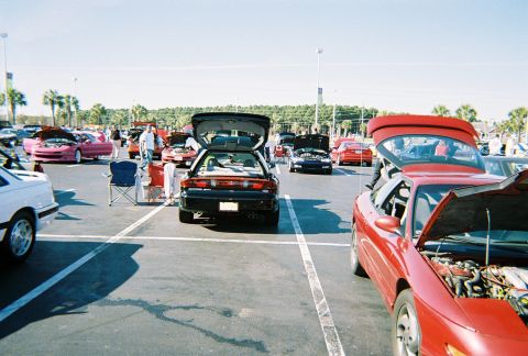 1991 Ford Probe - Cars displayed at an outdoor event, with several models open for viewing.