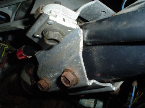 1984 Ford Bronco - Metal bracket with bolts and wiring, likely part of a vehicle's frame or suspension system.