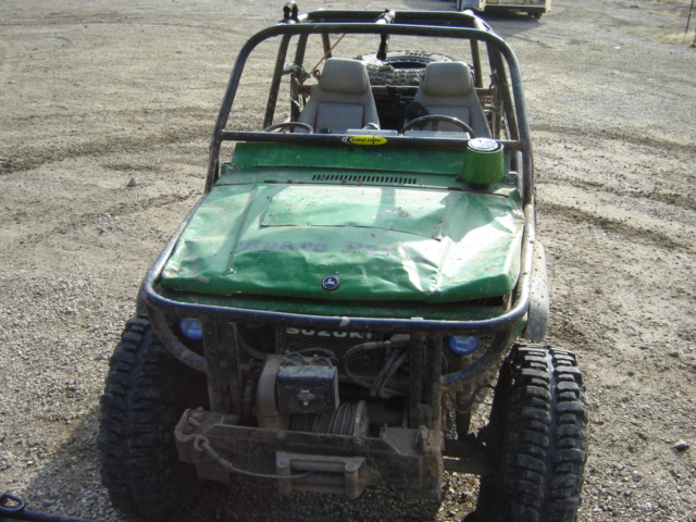 Green off-road buggy with roll cage and winch, front view
