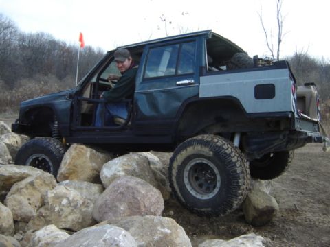 1992 Ford Bronco - This modified Jeep Cherokee XJ navigates a rocky trail with its doors removed.