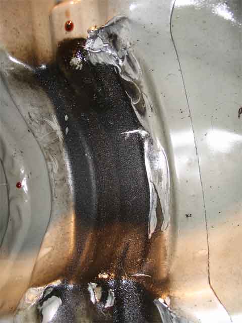 2001 Ford Crown Victoria - This is what the rotating driveshaft did to the body of my car. Good thing it didnt do much dammage.
