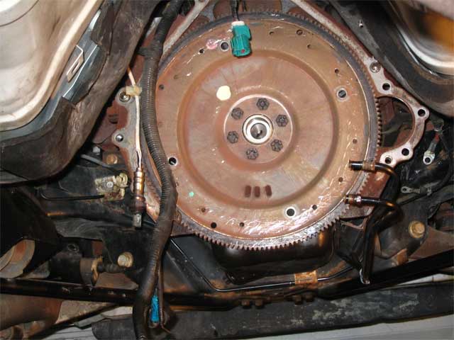 The back of my engine. Notice the screwdriver scratches on the flywheel. You have to move that torque conveter somehow. :)