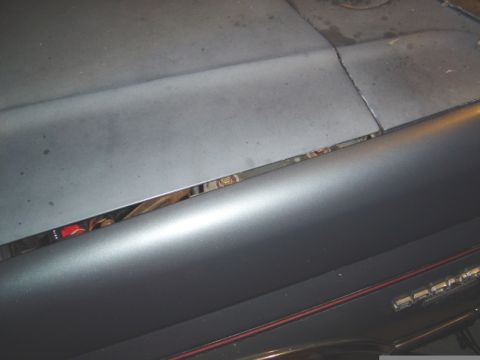 1986 Ford Bronco - A close-up view of the hood seam on a vehicle, revealing a glimpse of the engine compartment.