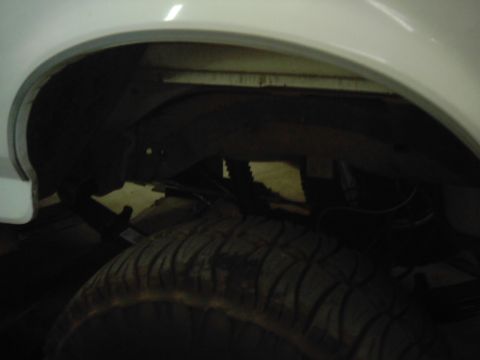 1978 Ford Bronco - The underside of a vehicle, showing the rear tire and suspension components.