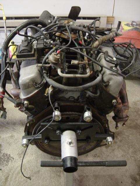 1991 Ford Bronco - Engine assembly mounted on an engine stand, showing complex wiring and plumbing.
