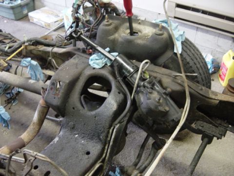 1991 Ford Bronco - Vehicle frame and suspension parts are disassembled, with a steering column visible.