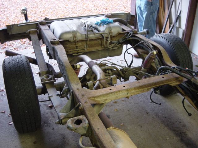 The damage to the frame at the mounts was pretty common in the back, caused by a combination of rust and wear as the mounts shifted.  Luckily this bracket doesn't need to be repaired, since it's going away ...