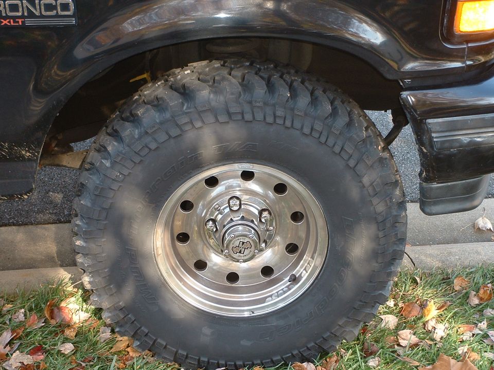 Black 1994 Ford Bronco XLT with off-road tire and chrome wheel