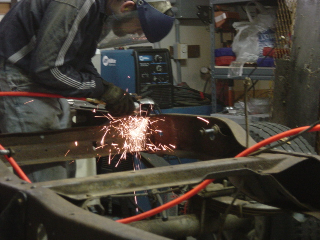 Cutting out some wafer-thin "dead" metal that will trap moisture and cause more rust later.
