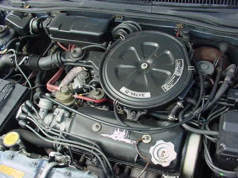 1996 Ford Probe - The engine compartment of a car is visible, with various hoses, wires, and the air filter assembly.