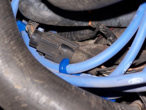 1986 Ford Bronco - Engine bay detail showing spark plug wires and a connector, likely part of an ignition system.