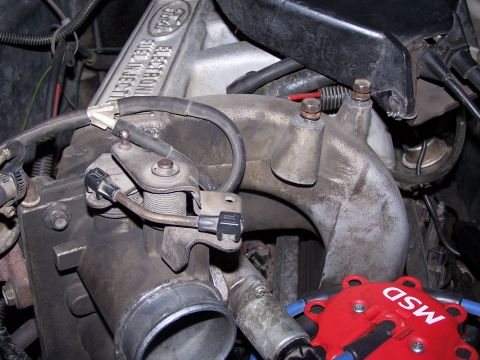 1986 Ford Bronco - Close-up of a Ford engine's intake manifold and throttle body, showing electronic fuel injection components.