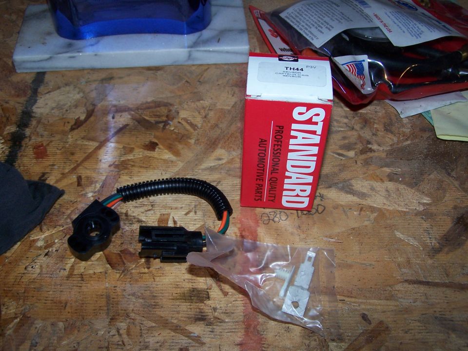 New Standard TH44 throttle position sensor and pigtail beside its red box on a workbench