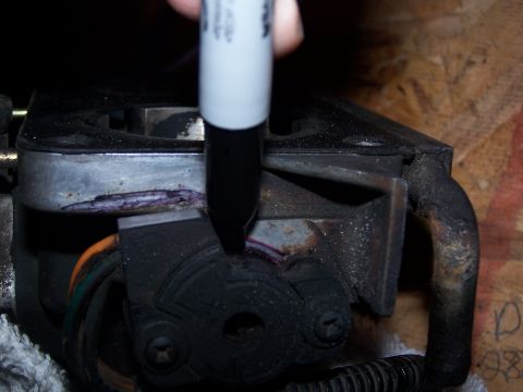 1986 Ford Bronco - A marker is used to mark a throttle body sensor, likely for adjustment or replacement.