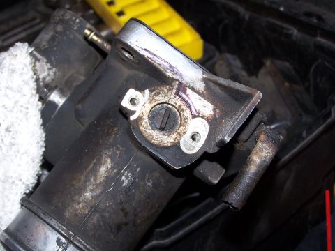 1986 Ford Bronco - Close-up of a throttle position sensor assembly, likely removed for cleaning or replacement.