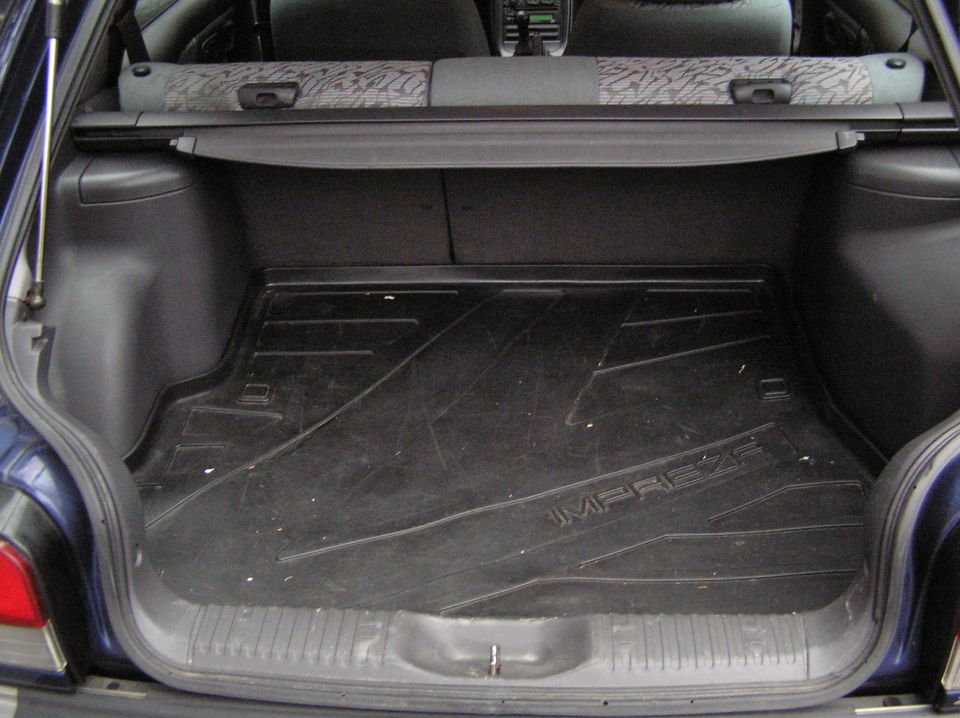 Subaru Impreza wagon cargo area with black rubber tray embossed IMPREZA and cargo cover