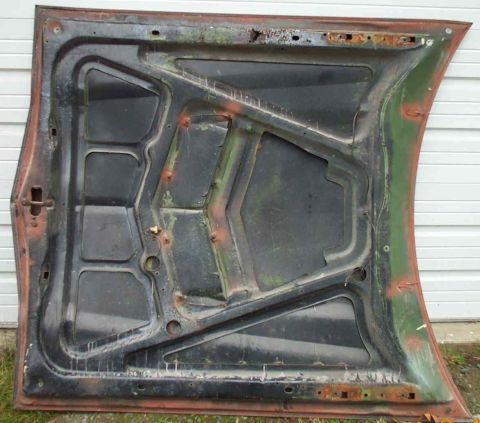 1970 Ford Torino - Underside of a green car hood, showing structural bracing and signs of age and rust.
