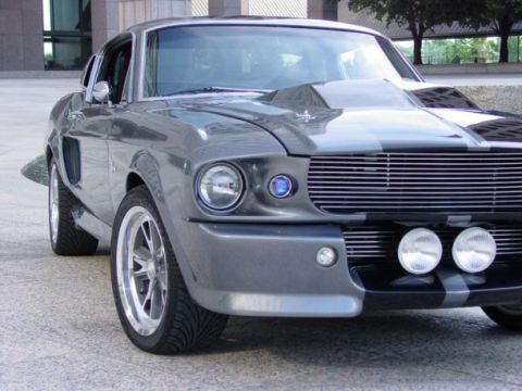 1986 Ford Bronco - Gray 1967 Shelby GT500 Mustang with racing stripes and aftermarket wheels.