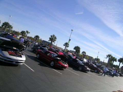 1993 Ford Probe - A silver 1993 Ford Probe is parked with its hood open, displaying the engine, alongside other vehicles.