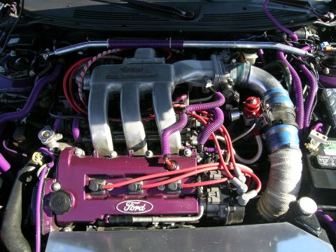 1993 Ford Probe - Engine bay detail with custom purple accents and a visible Ford badge.