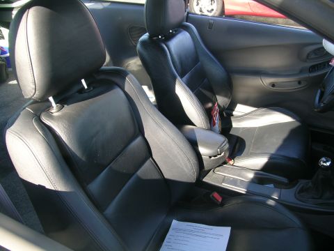 1993 Ford Probe - Interior view of a car's front seats and dashboard, with a document visible on the floor.