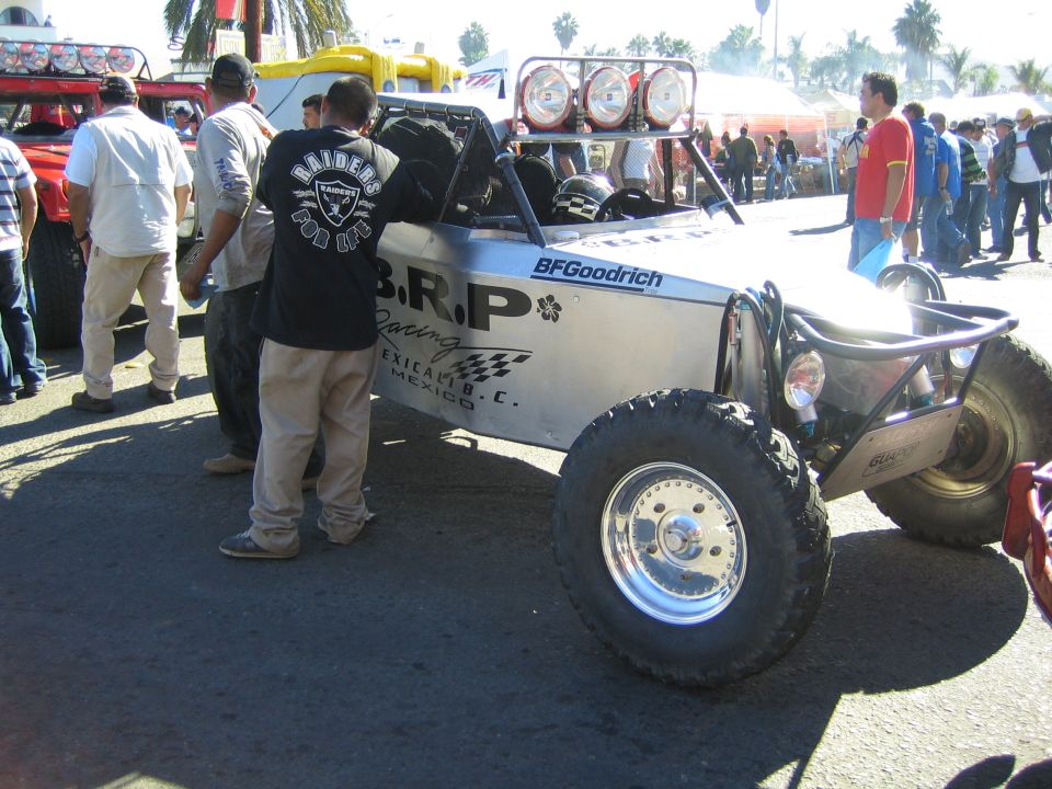 Silver off-road buggy with BRP Racing livery and roof light bar