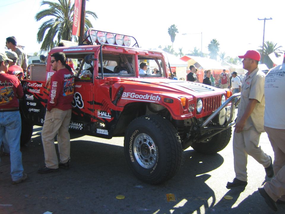 Red Hummer H1 off-road race truck number 53 with roof lights