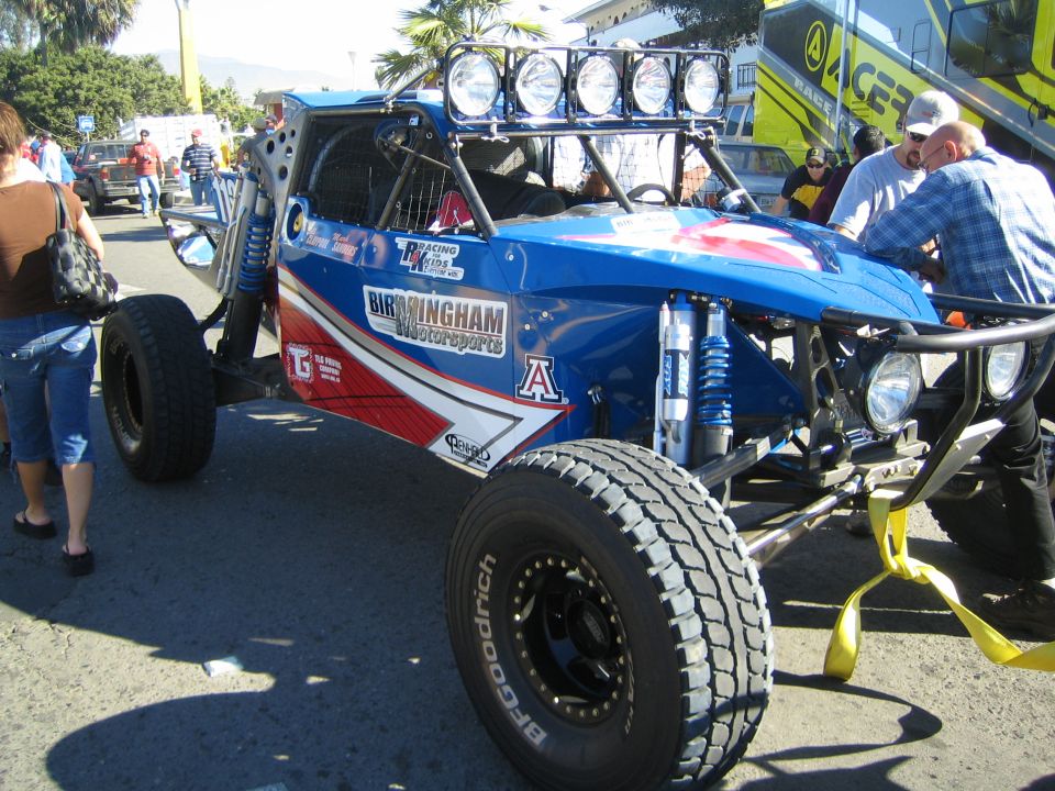 Blue and red off-road buggy with Birmingham Motorsports livery and roof lights
