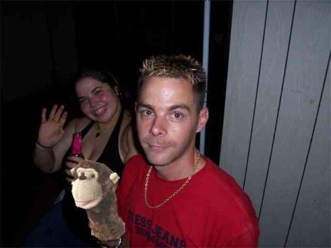1968 Ford Mustang - Two people pose for a photo, one holding a monkey puppet and the other a bottle.