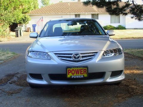2004 Mazda 6 - A silver 2004 Mazda 6 sedan is parked in a driveway, facing the camera directly.