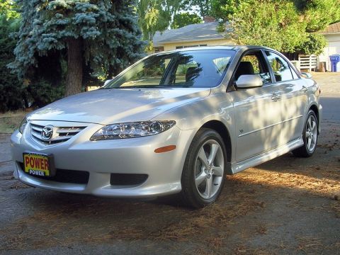 2004 Mazda 6 - Silver 2004 Mazda 6 sedan parked in a driveway, showing its front 3/4 view. The license plate reads 'POWER'.