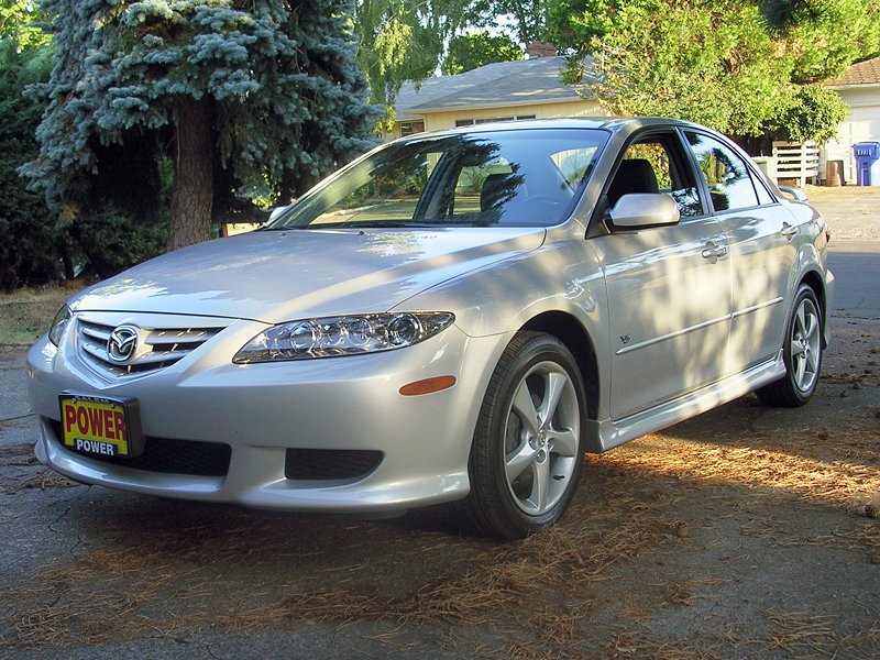 Silver 2004 Mazda 6 sedan, front 3/4 view. Yellow 'POWER' license plate