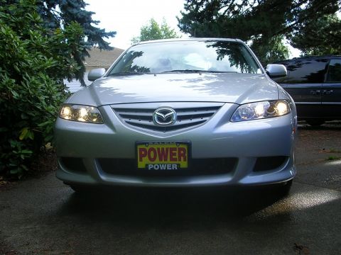 2004 Mazda 6 - Silver 2004 Mazda 6 sedan parked in a driveway, showing its front grille and headlights.