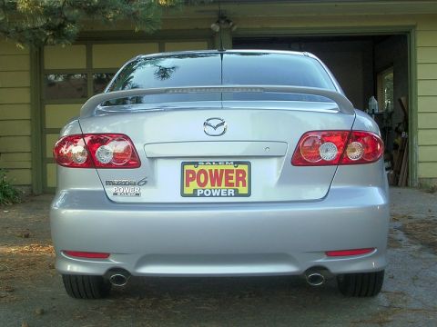 2004 Mazda 6 - Rear view of a silver 2004 Mazda 6 sedan parked in front of a garage.