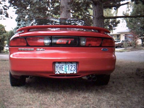 1996 Ford Probe - The rear of a red Ford Probe GT is shown, its distinctive taillights and a prominent GT badge.