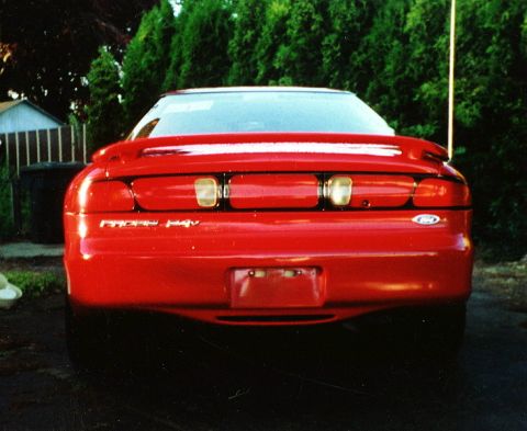 1996 Ford Probe - Rear view of a red car, identified by 'Probe GT' badging and a Ford emblem on the right side.