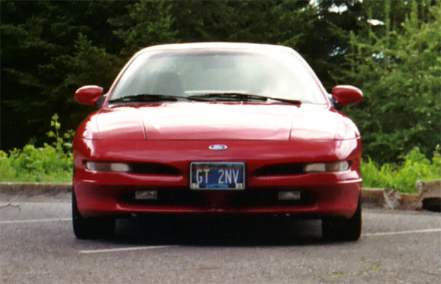 Front view of a red 1996 Ford Probe parked outdoors
