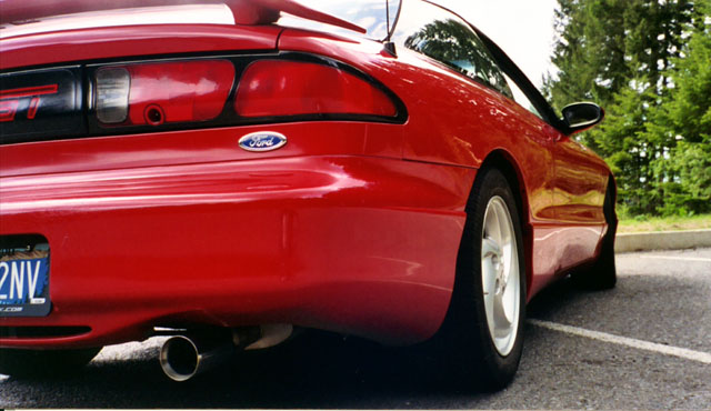 Red 1996 Ford Probe rear quarter view, showing taillight, Ford badge, and exhaust pipe