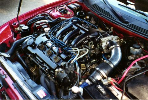 1996 Ford Probe - View of a car's engine bay, a V6 intake manifold and various engine components.
