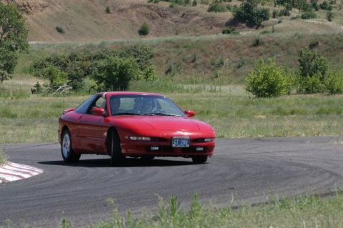 1996 Ford Probe - Red 1996 Ford Probe navigating a turn on a race track.