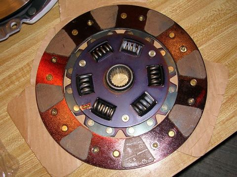1996 Ford Probe - A close-up view of a vehicle clutch disc, showing its friction material and spring mechanism.
