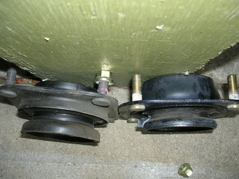 Two car strut mounts, one appears to be a replacement for the other