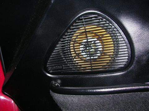 1996 Ford Probe - A close-up view of a car's interior door panel reveals a speaker grille.