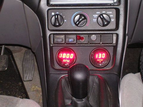 1996 Ford Probe - Aftermarket gauges display RPM and water temperature inside the vehicle's interior.