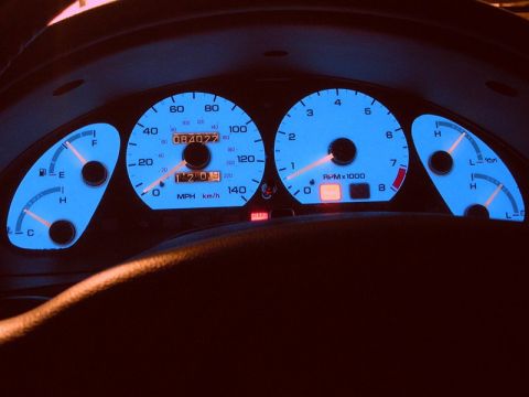 1996 Ford Probe - Dashboard gauges of a 1996 Ford Probe, illuminated in blue, display mileage and engine speed.